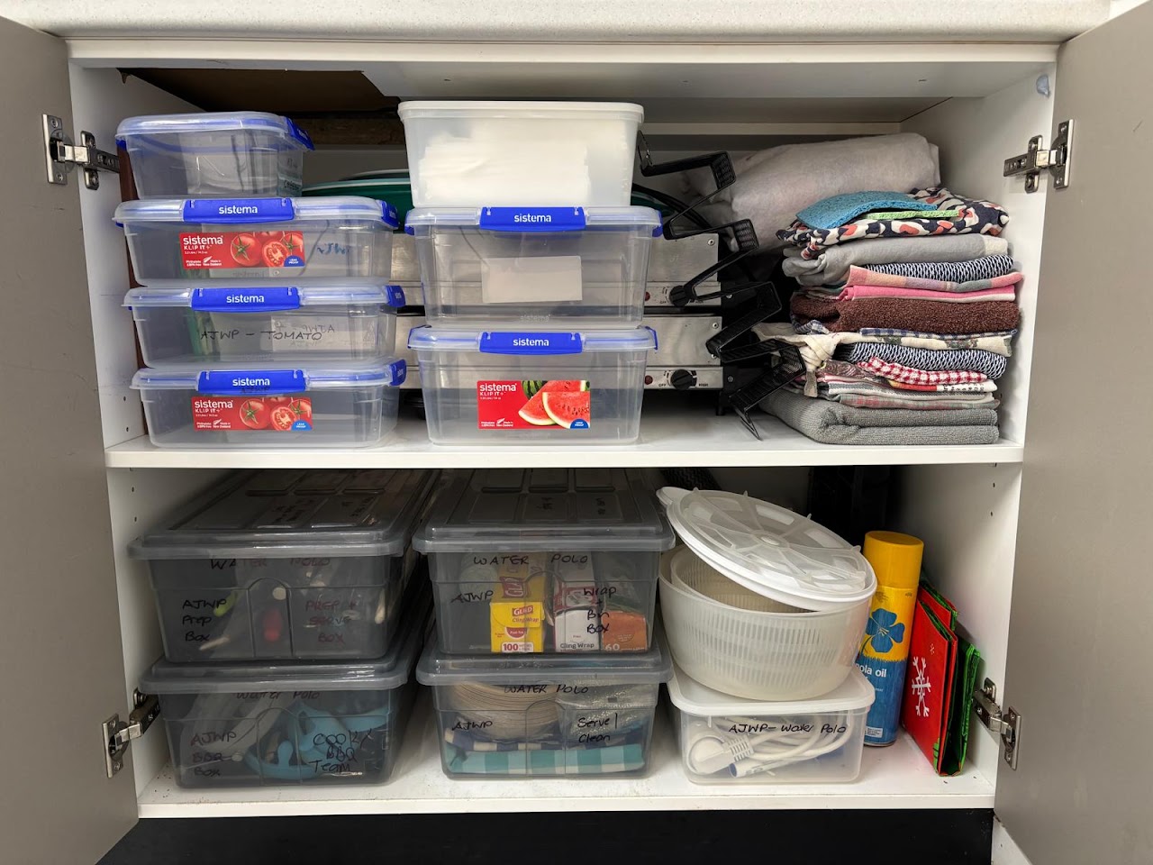 AJWP BBQ storage cupboard packed neatly with supplies